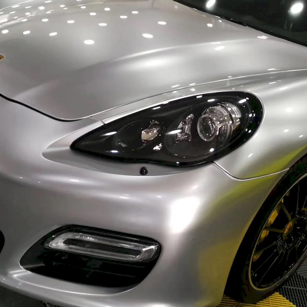 gloss silver car wrap installed on a sports car
