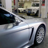 gloss silver car wrap being installed on a sedan