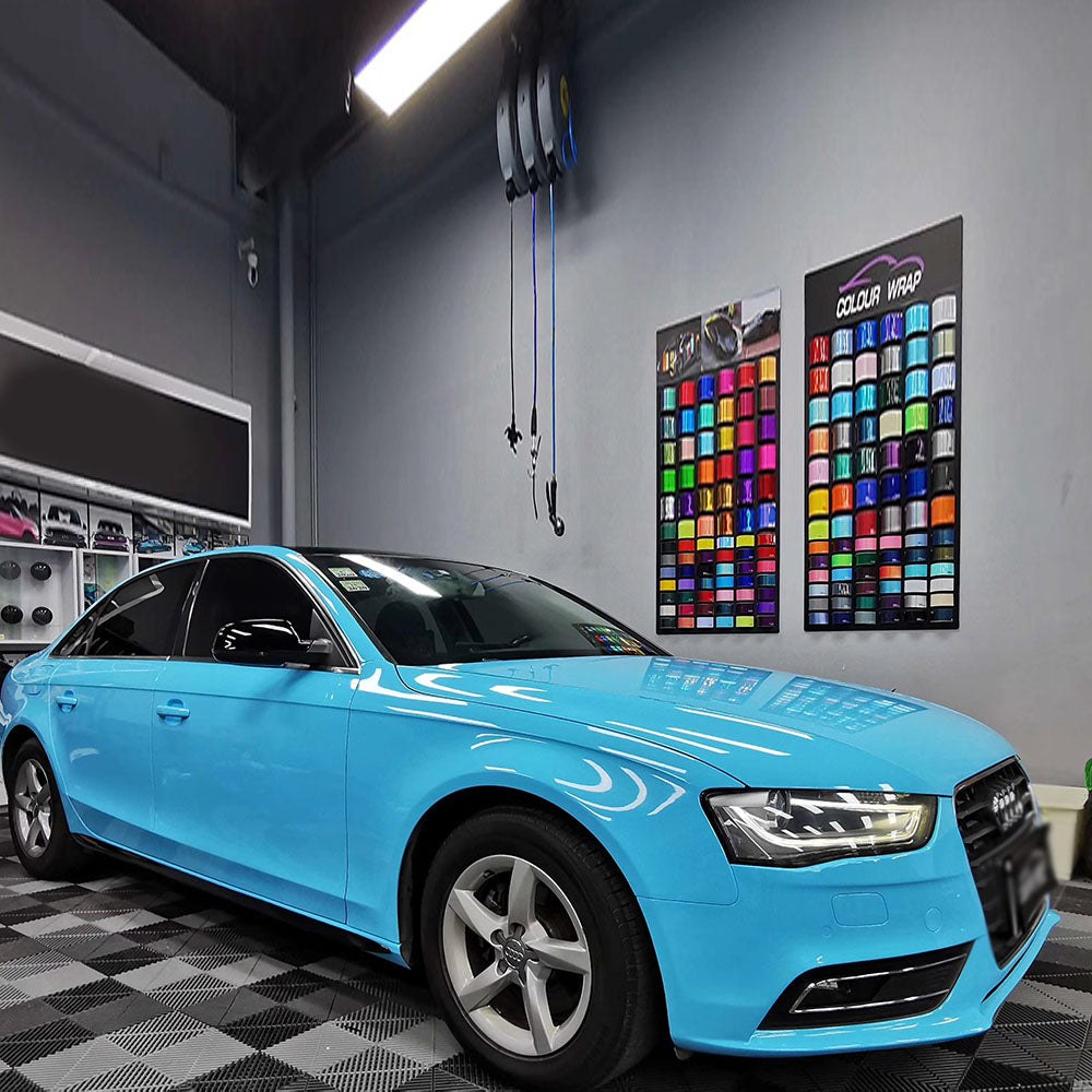 a sedan wrapped in gloss sky blue car wrap