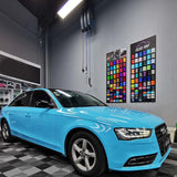 a sedan wrapped in gloss sky blue car wrap