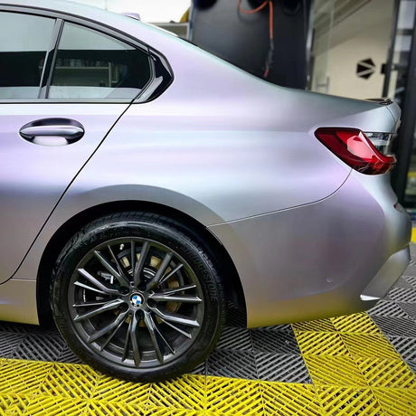 rear quarter panel of a car wrapped in matte capri purple grey car wrap