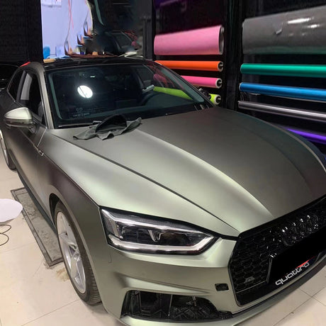 matte green grey car wrap being installed on a vehicle