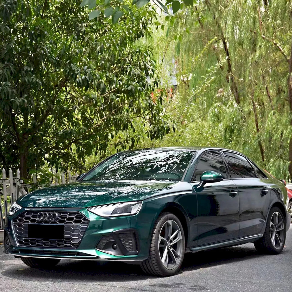 small sedan wrapped in metallic agate green car wrap
