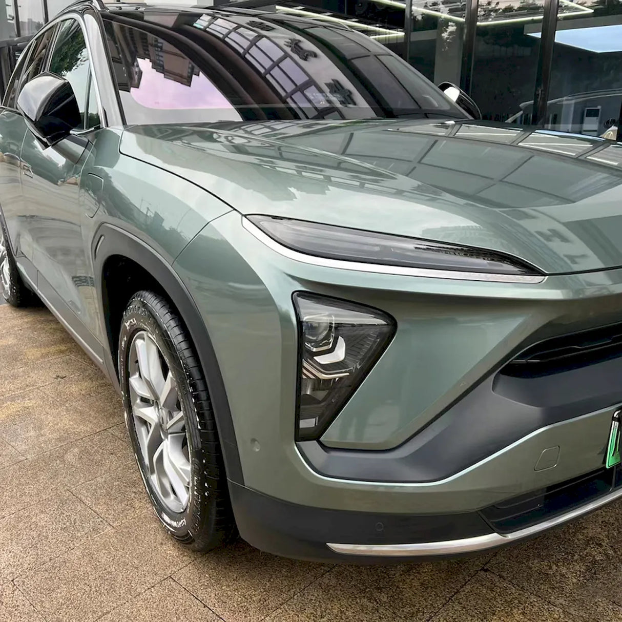 close up shot of metallic aurora green car vinyl wrap