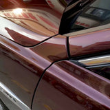close up of a vehicle wrapped in metallic black rose vinyl wrap