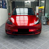 metallic cherry red vinyl wrap being installed on a tesla