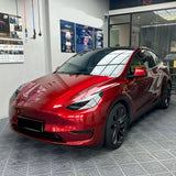 metallic cherry red vinyl wrap being installed on a car