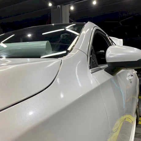 car being wrapped in metallic paint white car wrap