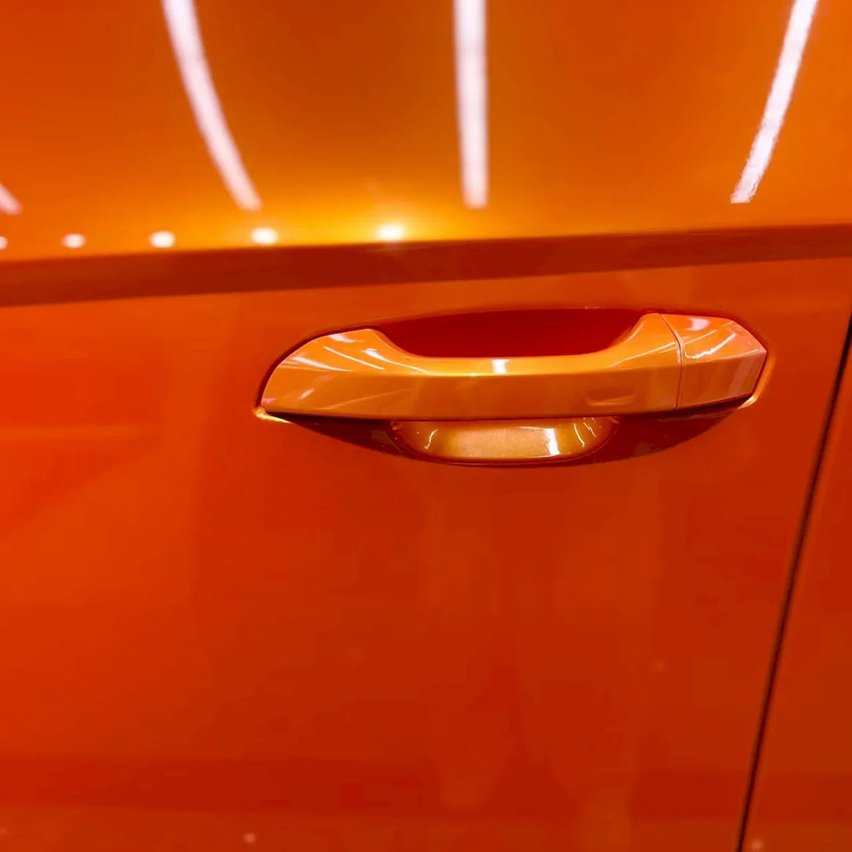 metallic racing golden orange car vinyl wrap installed on a vehicle