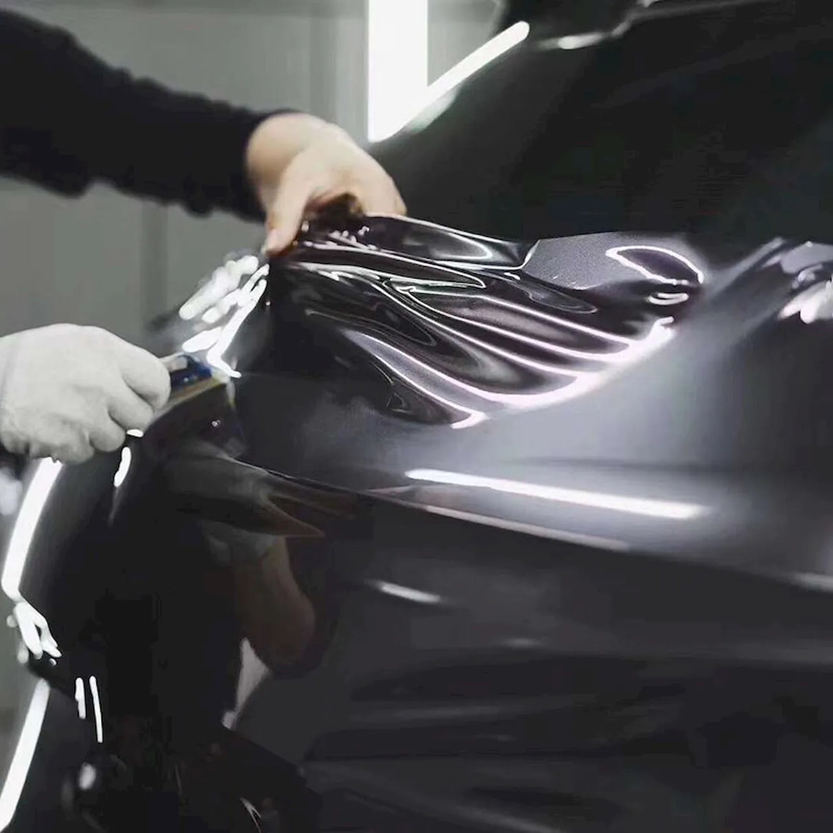 installation of space gray gloss car wrap