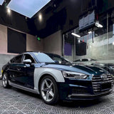 midnight green vinyl wrap being installed on a vehicle