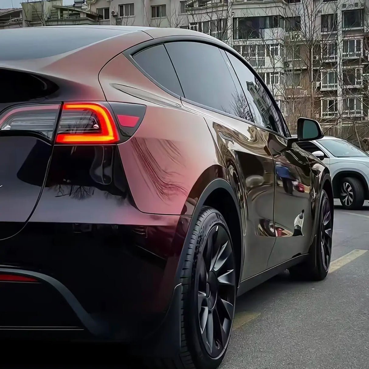 tesla model y wrapped in gloss phantom red (midnight metallic shift) car wrap