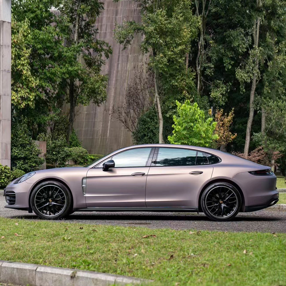 side angle of satin dbx purple car wrap that's installed on a car